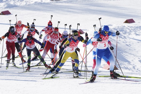 Biathletes ski during the women's 4x6-kilometer relay at the 2022 Winter Olympics, Wednesday, Feb. 16, 2022, in Zhangjiakou, China. (AP Photo/Carlos Osorio)