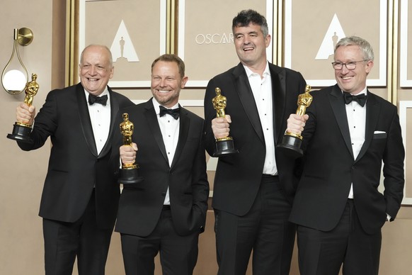 Joe Letteri, from left, Richard Baneham, Eric Saindon and Daniel Barrett, winners of the Best Visual Effects award for "Avatar: The way of the water" posing in the press room at the Oscars on…