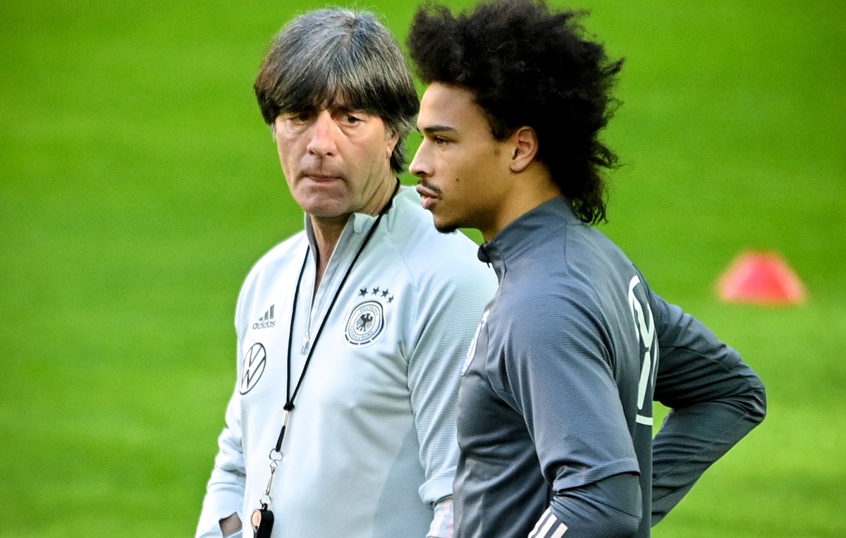 epa09106998 German national soccer team's head coach Joachim Loew (L) gives instructions to Leroy Sane (R) during their team's training session in Duesseldorf, Germany, 30 March 2021. German ...