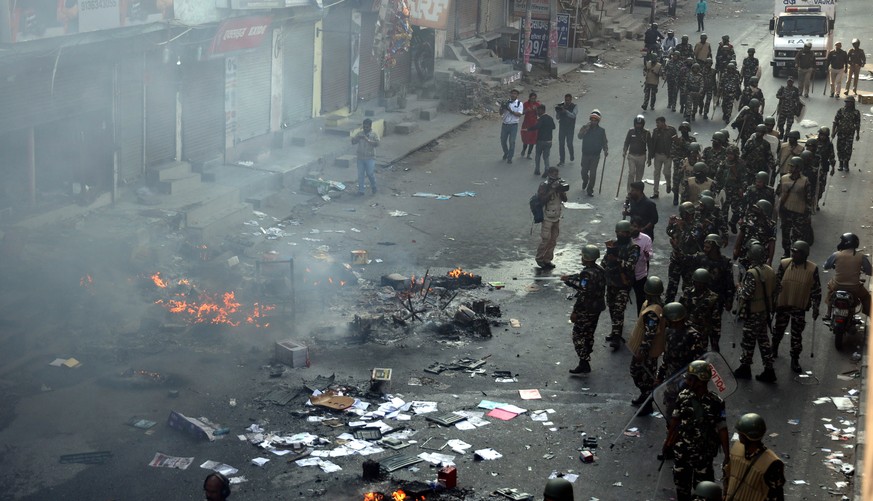 epa08247211 Indian security forces patrol near the site of violent clashes between opposing political factions in eastern Delhi, New Delhi, India, 25 February 2020. According to news reports, several  ...