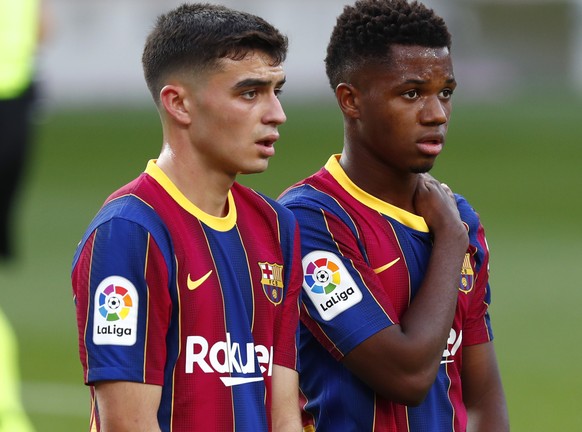 Barcelona&#039;s Pedri and Ansu Fati stand during the Spanish La Liga soccer match between FC Barcelona and Real Madrid at the Camp Nou stadium in Barcelona, Spain, Saturday, Oct. 24, 2020. (AP Photo/ ...