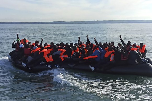 This photo provided by the Prefecture Maritime du Nord et de la Manche shows migrants continuing their journey to Britain off northern France coast, Tuesday, April 23, 2024. Five people, including a c ...