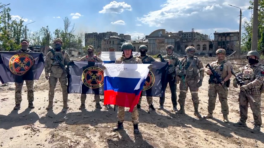 In this handout photo taken from video and released by Prigozhin Press Service Saturday, May 20, 2023, Yevgeny Prigozhin, the head of the Wagner Group military company speaks holding a Russian nationa ...
