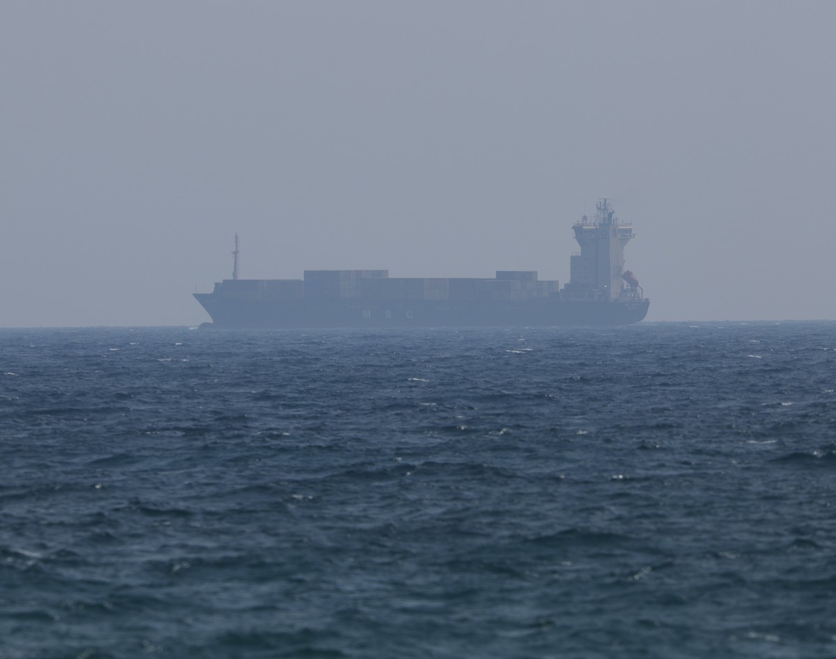epa12192584 A container ship sails on the Strait of Hormuz, as seen from Ras Al Khaimah, United Arab Emirates, 23 June 2025. The Strait lies between Oman and Iran and links the Gulf to the Arabian Sea ...