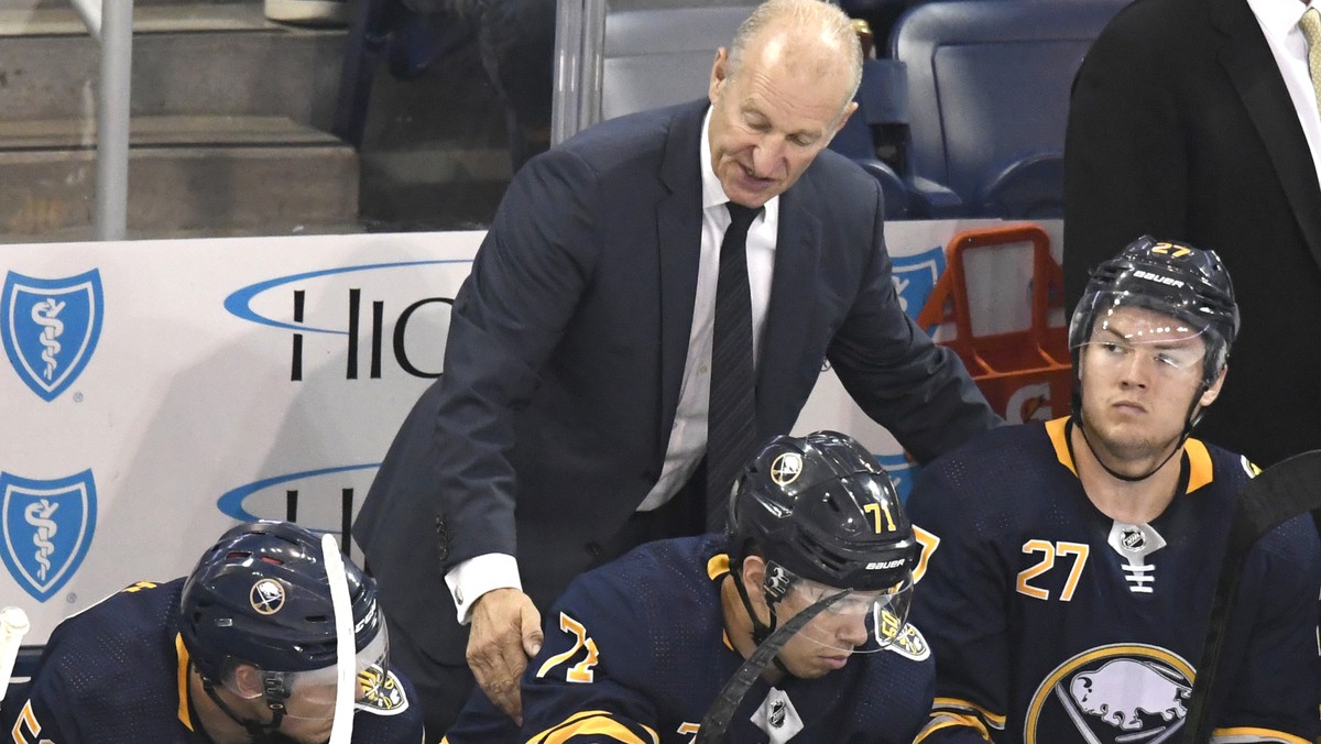 Buffalo Sabres head coach Ralph Krueger, top, talks with Sabres players Jeff Skinner (53), Evan Rodrigues (71) and Curtis Lazar (27) during an NHL preseason hockey game against the Pittsburgh Penguins ...