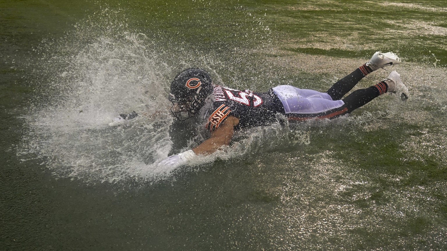 Chicago Bears&#039; Sterling Weatherford celebrates by sliding in a puddle after an NFL football game against the San Francisco 49ers Sunday, Sept. 11, 2022, in Chicago. The Bears won 19-10. (AP Photo ...