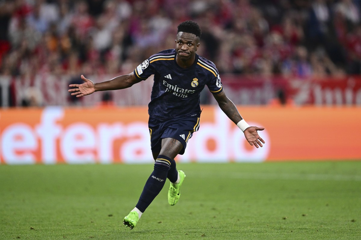 Real Madrid's Vinicius Junior celebrates after scoring his side's second goal on a penalty kick during the Champions League semifinal first leg soccer match between Bayern Munich and Real Ma ...