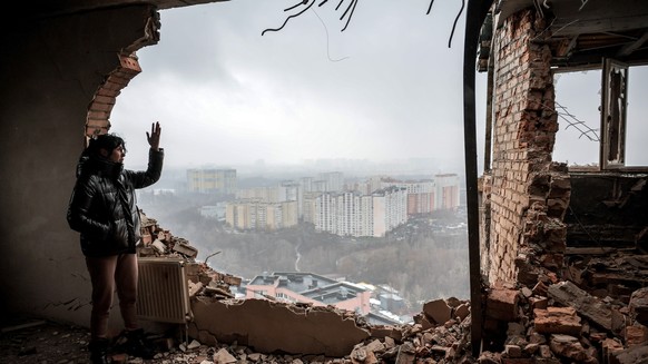 epa11040621 Local resident Tetiana (40) inspects her ruined flat at the site of a drone attack on a residential building in Kyiv (Kiev), Ukraine, 22 December 2023, amid the Russian invasion. At least  ...