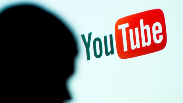Archive - January 19, 2017, Bavaria, Bamberg: The image shows a shadow in front of the YouTube logo.  (to dpa 