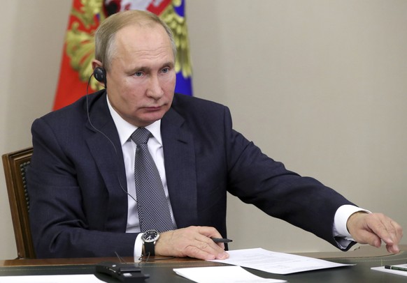 Russian President Vladimir Putin attends a joint video conference with Chinese President Xi Jinping during inaugurating the Power of Siberia pipeline in the Bocharov Ruchei residence in the Black Sea ...