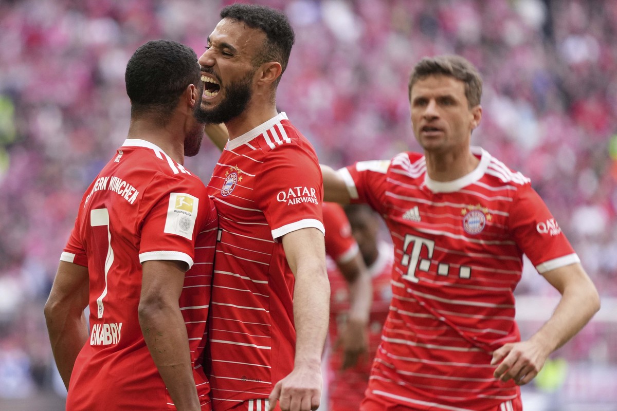 FILE - Bayern's Serge Gnabry, left, celebrates besides team mate Bayern's Noussair Mazraoui and Bayern's Thomas Mueller after scoring his side's opening goal during the German Bund ...
