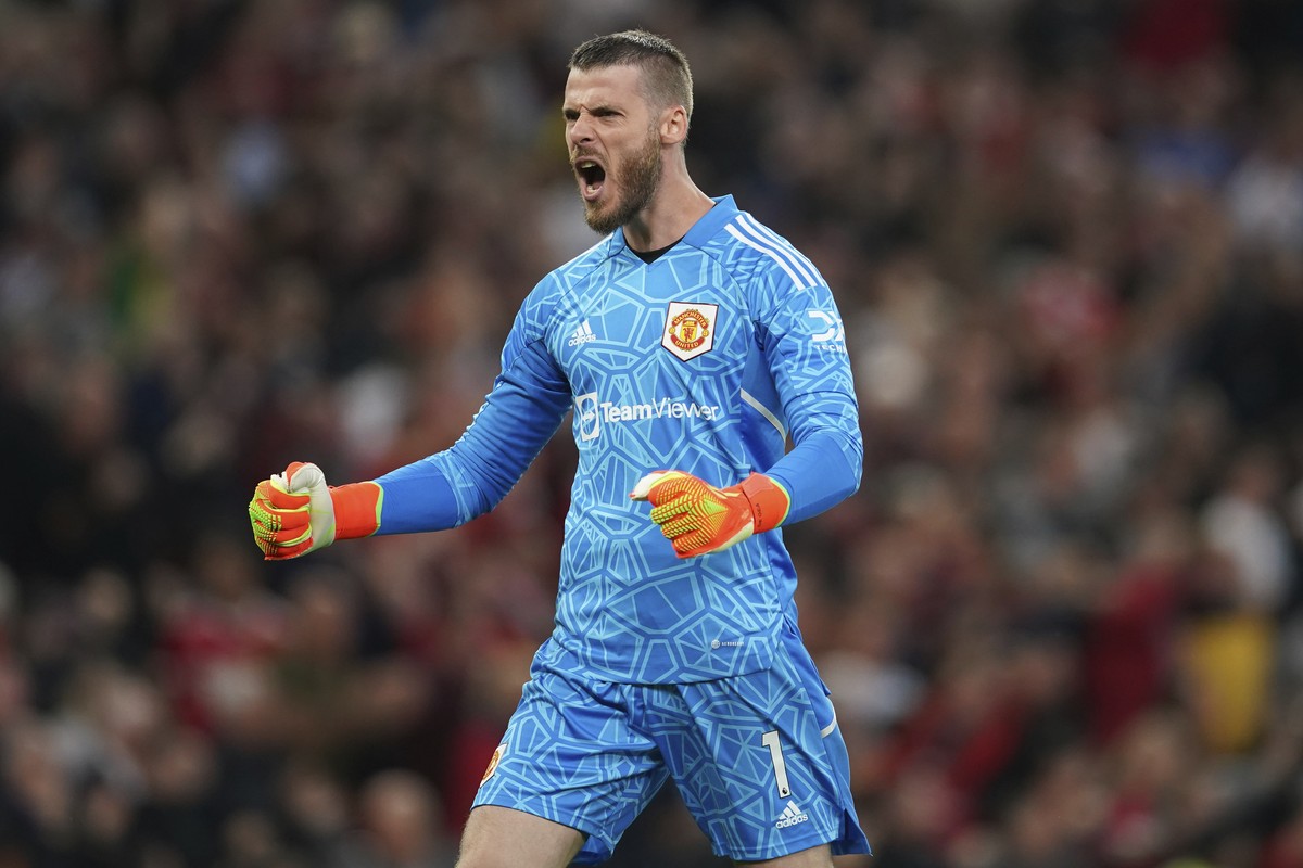Manchester United's goalkeeper David de Gea celebrates after his teammate Jadon Sancho scored his side's first goal during the English Premier League soccer match between Manchester United a ...