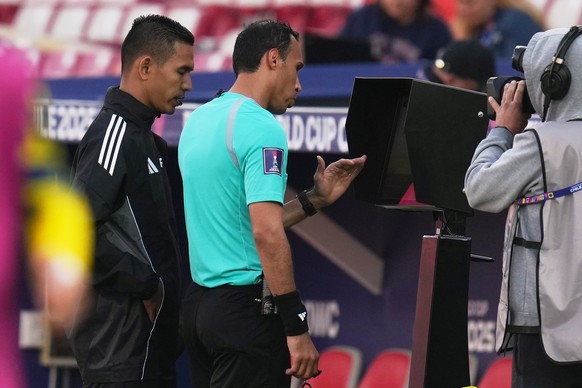 Referee Khalid Saleh Alturais checks the VAR screen during a FIFA U-20 World Cup Group B soccer match between Ukraine and Paraguay at National Stadium in Santiago, Chile, Friday, Oct. 3, 2025. (AP Pho ...
