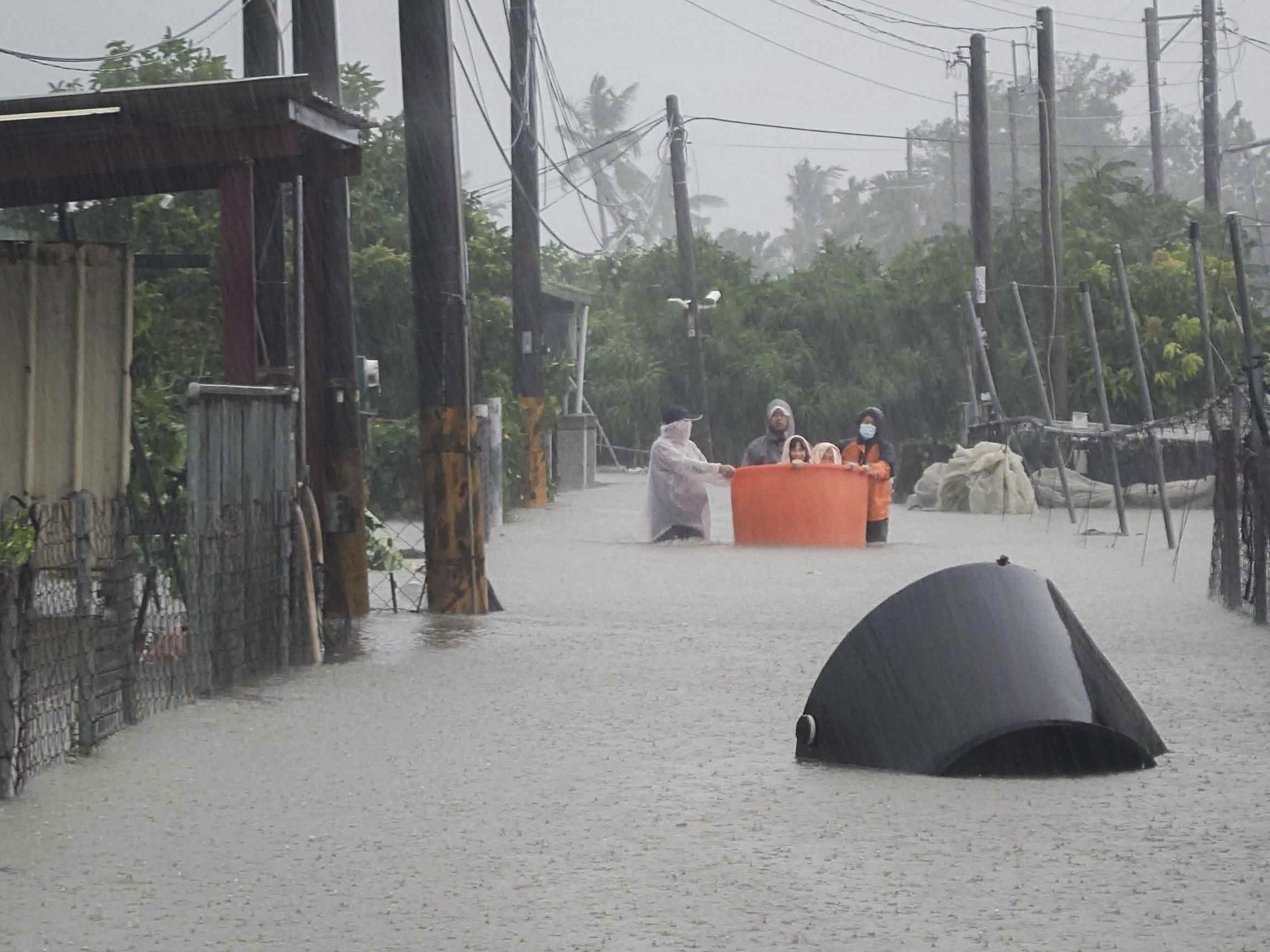 This photo released by Pingtung Fire Department shows, local residents being evacuated during floods after Typhoon Gaemi made landfall in Pintung county, Taiwan, Thursday, July 25, 2024. (Pingtung Fir ...
