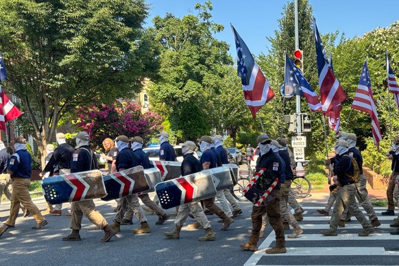 In this image provided by Mark Sherman, members of the group Patriot Front wear masks as they march through Washington before Independence Day events honoring the nation's 250th anniversary, Satu ...