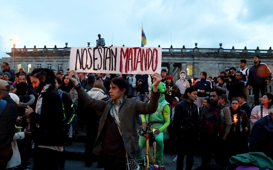 epa06870051 People participate in a vigil as a protest against the killing of social leaders in Bogota, Colombia, 06 July 2018. The Attorney General of Colombia attributed the murder of social leaders ...