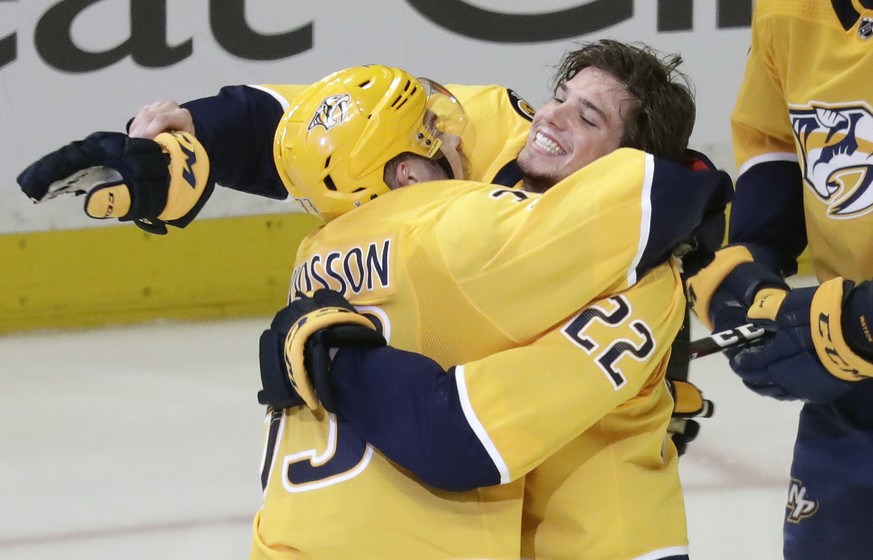 Nashville Predators left wing Kevin Fiala (22), of Switzerland, celebrates with Viktor Arvidsson, of Sweden, after Fiala scored the winning goal against the Winnipeg Jets during the second overtime in ...