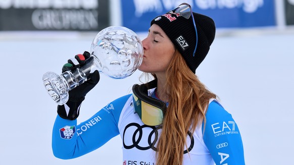 Italy's Sofia Goggia kisses the globe trophy for the super-G discipline title after winning an alpine ski, women's super-G race, at the Lillehammer World Cup Finals, in Kvitfjell, Norway, Su ...