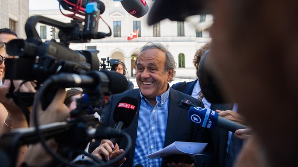 The former president of the the European Football Association (Uefa), Michel Platini, center, surrounded by media representatives, speaks to the press in front of the Swiss Federal Criminal Court in B ...