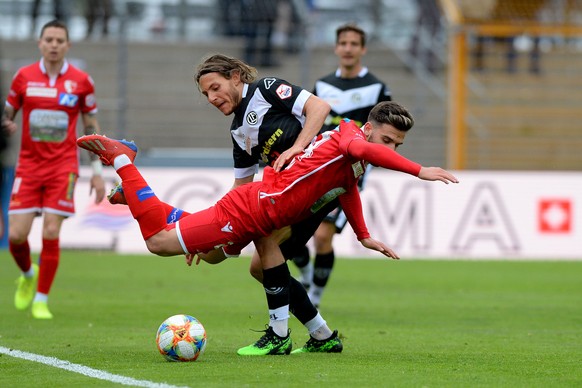 Lugano&#039;s player Numa Lavanchy, left, fight for the ball with Sion&#039;s player Bastien Toma, front, during the Super League soccer match FC Lugano against FC Sion, at the Cornaredo stadium in Lu ...