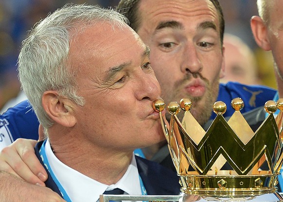 epa05811305 (FILE) - A file picture dated 07 May 2016 shows Leicester City manager Claudio Ranieri kisses the Premier League trophy after the English Premier League match between Leicester City and Ev ...