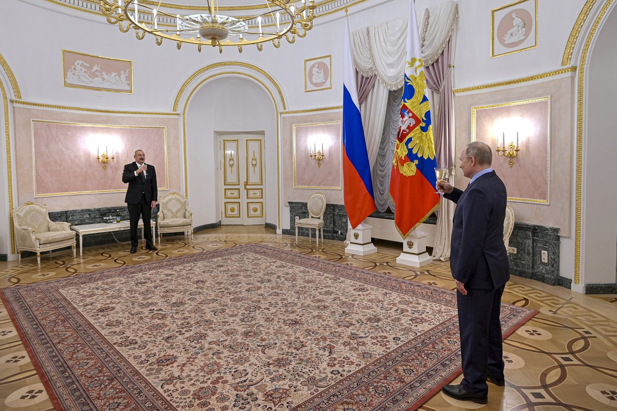 Russian President Vladimir Putin, right, toasts with Azerbaijani President Ilham Aliyev after their talks in the Kremlin in Moscow, Russia, Tuesday, Feb. 22, 2022. (Mikhail Klimentyev, Sputnik, Kremli ...