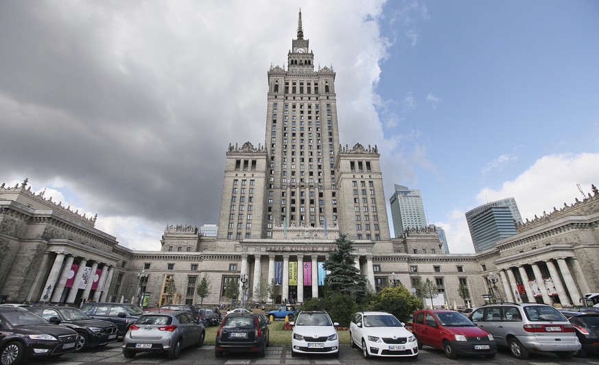 FILE - In this July 20, 2015 file photo, cars are parked in front of the Palace of Culture and Science in Warsaw, Poland. Two leading members of the Polish government are calling for the destruction o ...