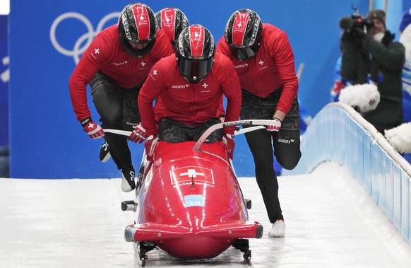 Michael Vogt of Switzerland and his team start during a 4-man bobsleigh training heat at the 2022 Winter Olympics, Wednesday, Feb. 16, 2022, in the Yanqing district of Beijing. (AP Photo/Dmitri Lovets ...