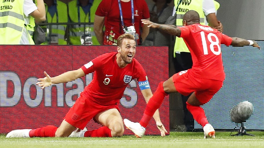 epa06819831 Harry Kane (L) of England celebrates with his teammate Ashley Young (R) after scoring the winning goal during the FIFA World Cup 2018 group G preliminary round soccer match between Tunisia ...