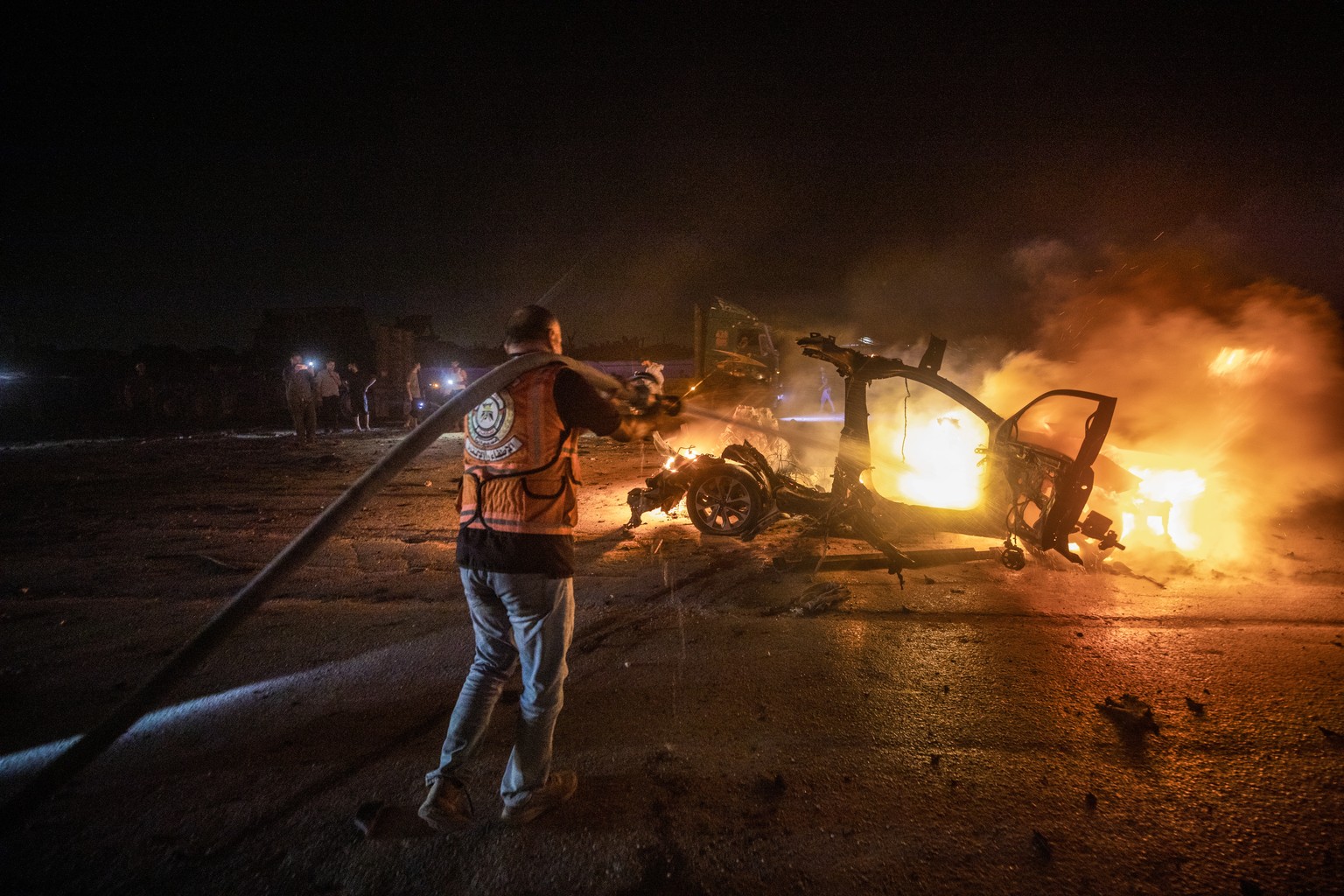 epaselect epa13149105 Palestinian Civil Defense personnel extinguish a fire in a destroyed car following an Israeli airstrike on Al-Rashid Road next to the beach in southern Gaza City, 03 August 2026. ...