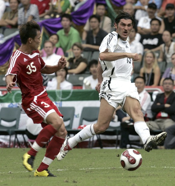 FILE - FIFA World Stars team&#039;s Mikheil Kavelashvili, right, makes a shot on the goal during the Reunification Cup against Chinese national team in Hong Kong, on July 1, 2007. (AP Photo/Brian Chin ...