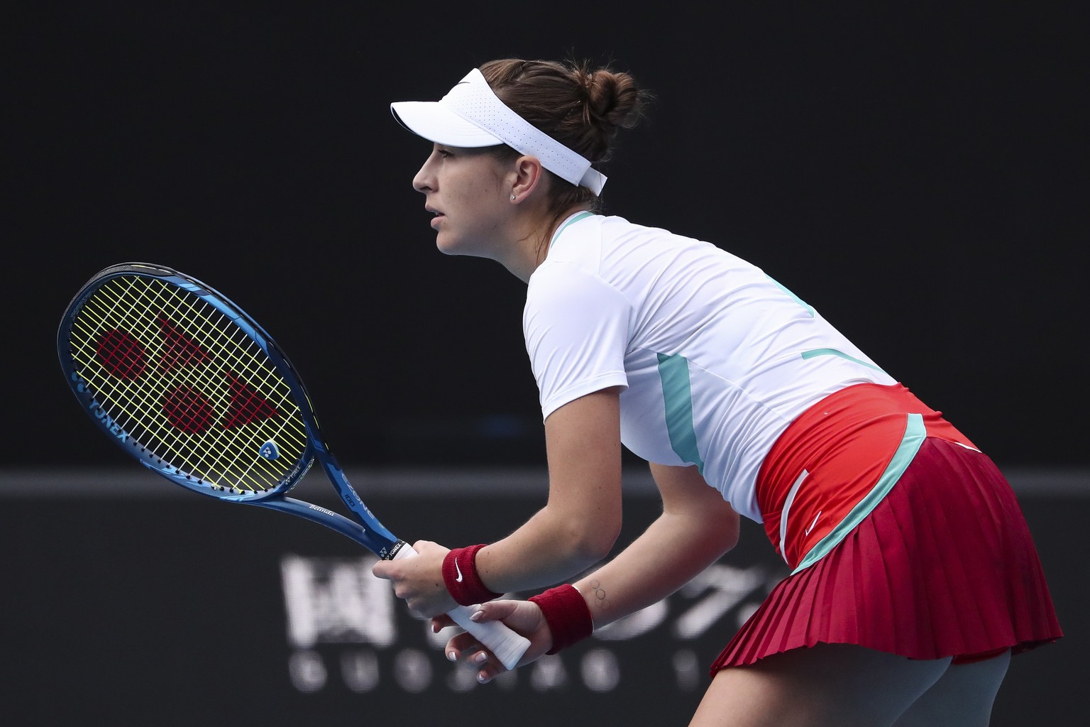 epa09690170 Belinda Bencic of Switzerland in action against Kristina Mladenovic of France during their first round match at the Australian Open Grand Slam tennis tournament in Melbourne, Australia, 17 ...