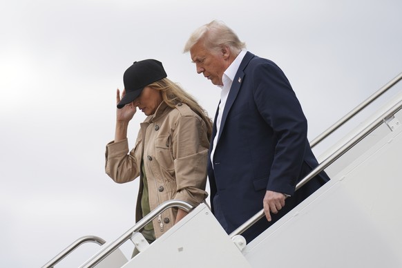 President Donald Trump, right, and first lady Melania Trump arrive on Air Force One at Kelly Field air base in San Antonio, Texas, en route to observe flood damage in Kerrville, Texas, Friday, July 11 ...
