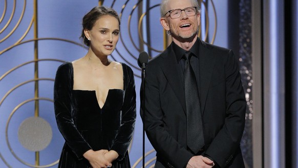 This image released by NBC shows presenters Natalie Portman, left, and Ron Howard at the 75th Annual Golden Globe Awards in Beverly Hills, Calif., on Sunday, Jan. 7, 2018. (Paul Drinkwater/NBC via AP)