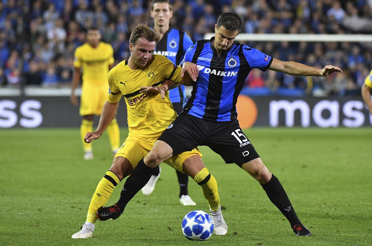 Dortmund's Mario Goetze, left, and Brugge defender Matej Mitrovic challenge for the ball during the Champions League group A soccer match between Club Brugge and Borussia Dortmund at the Jan Brey ...