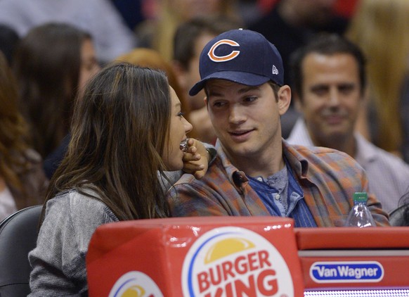 Actors Mila Kunis, left, and Ashton Kutcher watch the Los Angeles Clippers play the Detroit Pistons during the second half of an NBA basketball game, Saturday, March 22, 2014, in Los Angeles. (AP Phot ...
