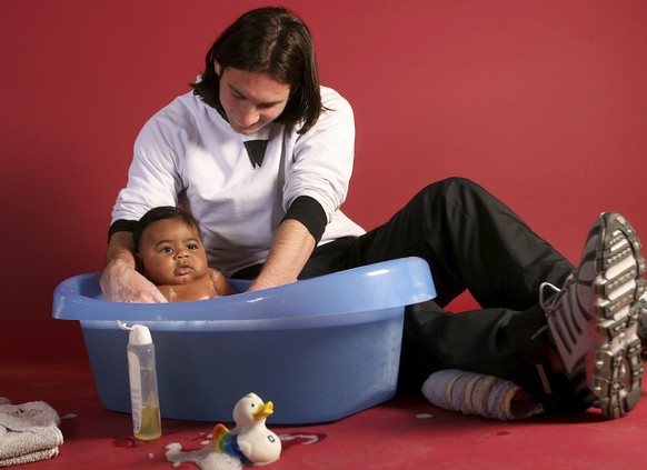 This photo taken in Sept. 2007 shows a 20-year-old Lionel Messi, who had embarked on his legendary Barcelona career just over four years prior, helping to bathe Lamine Yamal, who was merely six months ...