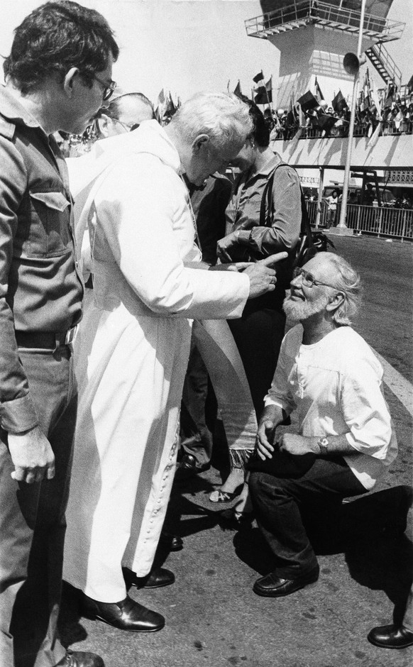 FILE - In this March 4, 1983 file photo, Daniel Ortega flanks Pope John Paul II who wags his finger at Culture Minister and priest Ernesto Cardenal, during welcoming ceremonies at the airport in Manag ...
