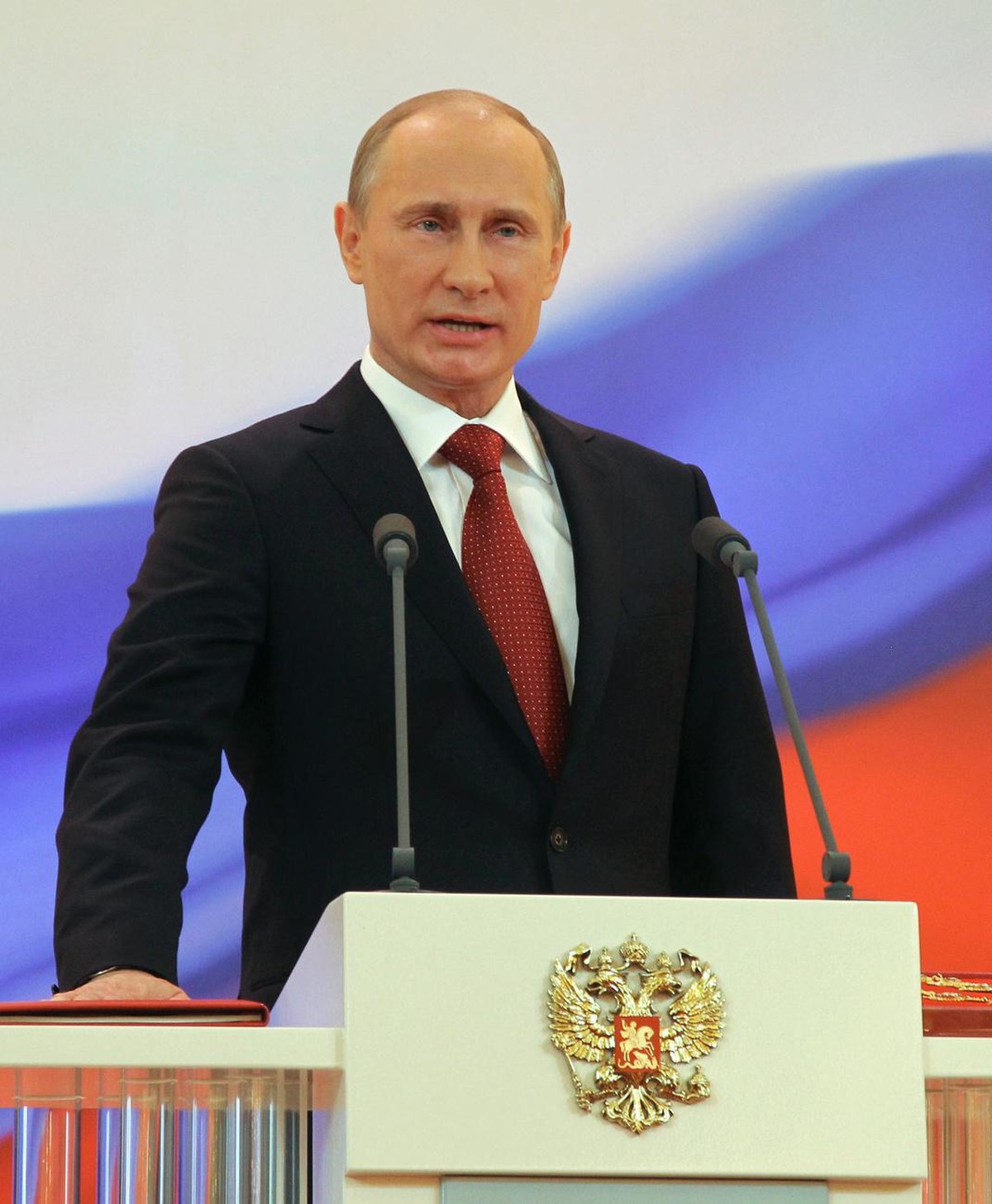 Vladimir Putin speaks with his hand on the Constitution during his inauguration ceremony as new Russia's president in Moscow on Monday, May 7, 2012. Putin has been sworn in as Russia's presi ...