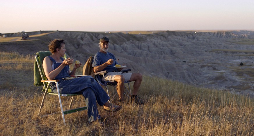 This image released by Searchlight Pictures shows Frances McDormand, left, and and David Strathairn in a scene from the film &quot;Nomadland.&quot; (Searchlight Pictures via AP)