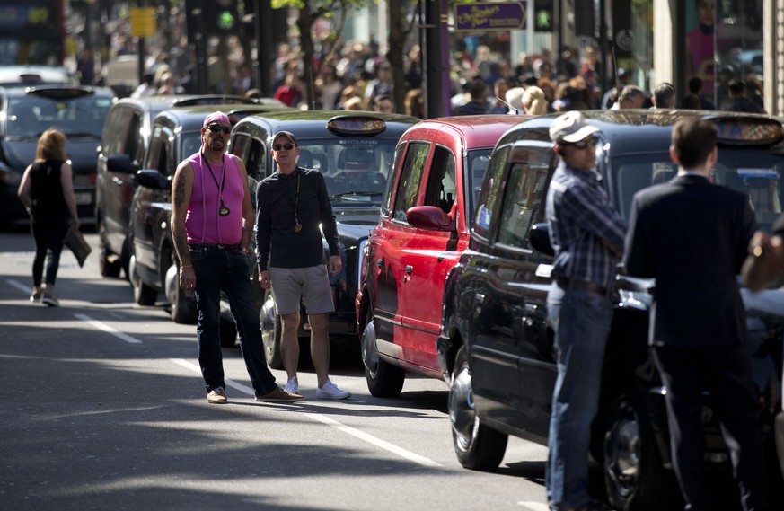 London taxi drivers block the traffic during their two-hour protest on Oxford Street in London, Tuesday, April 21, 2015. The protest Tuesday was organized by the United Cabbies Group over issues inclu ...