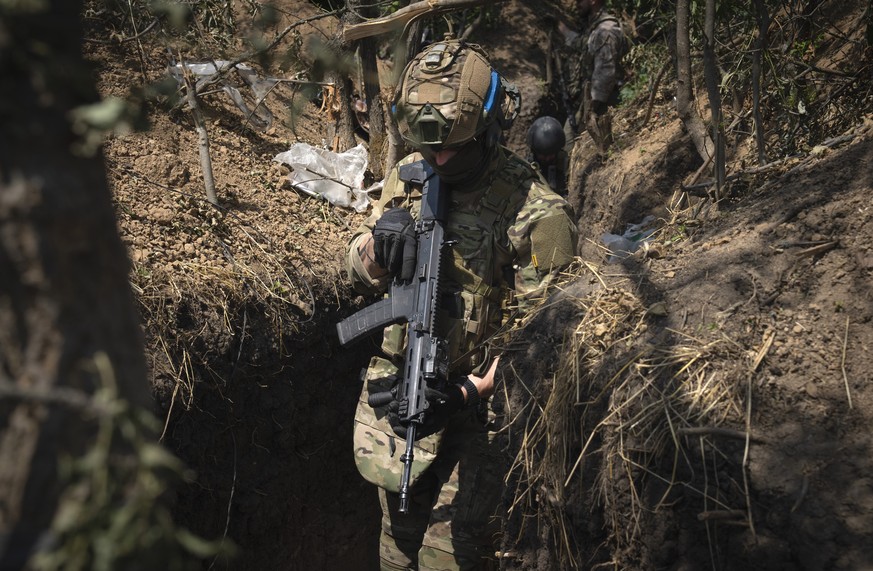 Ukrainian soldiers walk in a front-line trench in Zaporizhzhia region, Ukraine, Friday, June 23, 2023. (AP Photo/Efrem Lukatsky)
