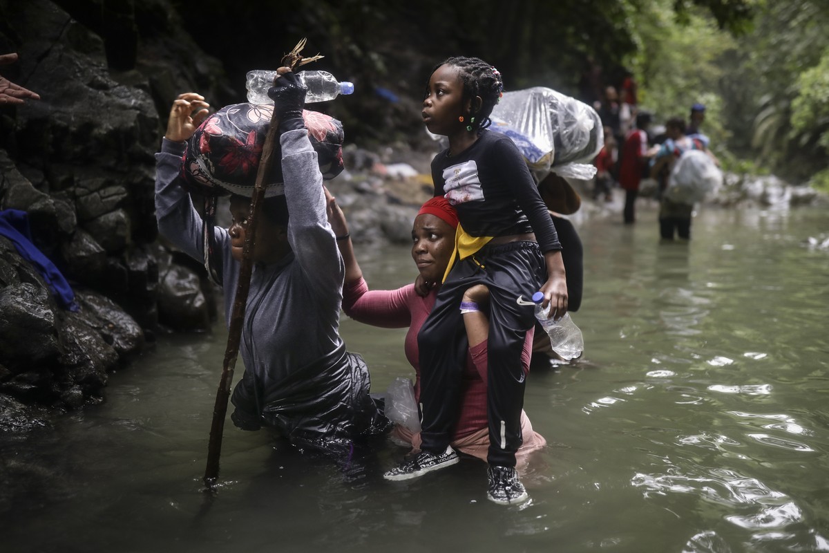 Haitian migrants wade through water as they cross the Darien Gap from Colombia to Panama in hopes of reaching the U.S., Tuesday, May 9, 2023. The image was part of a series by Associated Press photogr ...