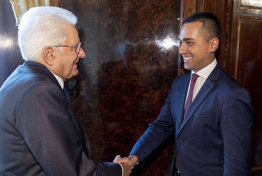 epa07786117 A handout photo made available by Quirinale Palace shows the President of the Republic Sergio Mattarella shaking hands with Luigi Di Maio (R), M5S leader, at Quirinale Palace for the first ...