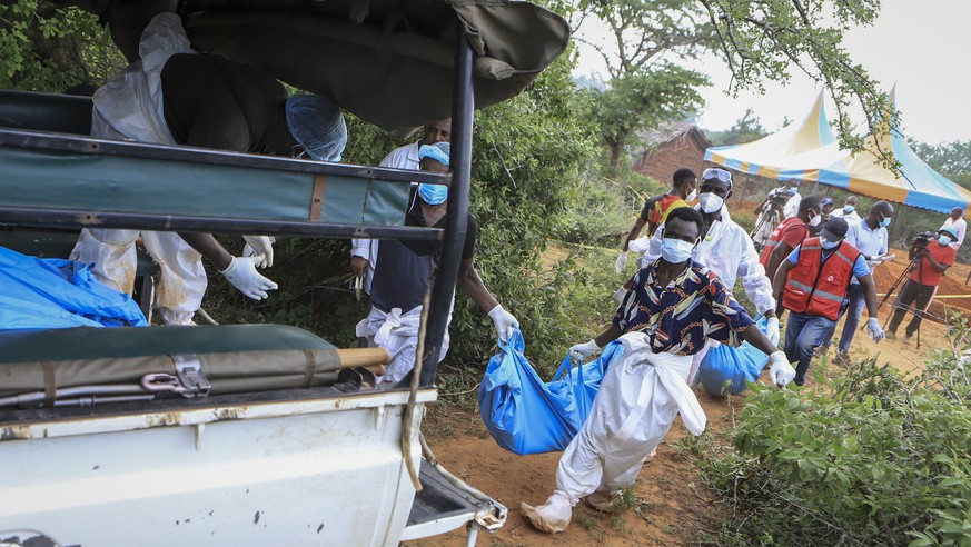 Police and local residents load the exhumed bodies of victims of a religious cult into the back of a truck in the village of Shakahola, near the coastal city of Malindi, in southeastern Kenya Sunday,  ...