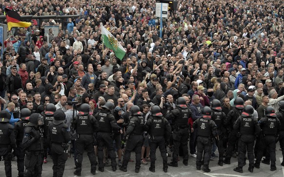 Men shout during a far-right protest in Chemnitz, Germany, Monday, Aug. 27, 2018 after a man has died and two others were injured in an altercation between several people of &quot;various nationalitie ...