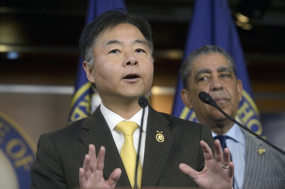 Congressional Hispanic Caucus Chair Rep. Adriano Espaillat, D-N.Y., right, listens while Rep. Ted Lieu, D-Calif., speaks on Trump's immigration executive orders at the Capitol, Thursday, Jan. 23, ...