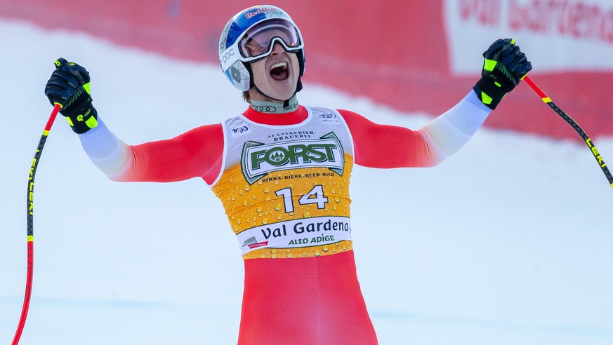 epa11788446 Marco Odermatt of Switzerland celebrates in the finish area during the Men&#039;s Downhill race at the FIS Alpine Skiing World Cup in Val Gardena, Italy, 21 December 2024. EPA/LUCIANO SOLE ...