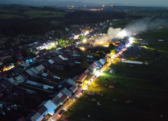 epa09287277 An aerial picture made with a drone for the scene of a fire in Nowa Biala, south Poland, 19 June 2021. At least nine people were injured in the fire that burnt some 13 residential building ...