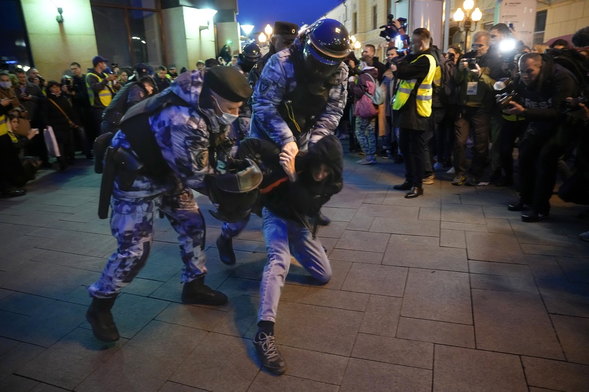 Riot police detain a demonstrator during a protest against mobilization in Moscow, Russia, Wednesday, Sept. 21, 2022. Russian President Vladimir Putin has ordered a partial mobilization of reservists  ...